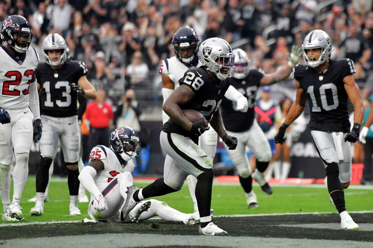 Las Vegas Raiders running back Josh Jacobs (28) scores a touchdown during the second half of an NFL football game against the Houston Texans, Sunday, Oct. 23, 2022, in Las Vegas.