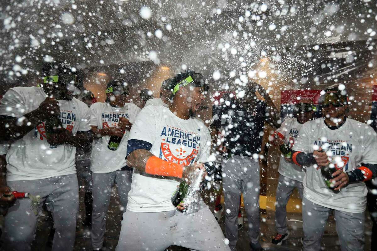 Houston Astros catcher Martin Maldonado, center, celebrates in the clubhouse after winning the American League pennant with a sweep of the New York Yankees at Yankee Stadium on Sunday, Oct. 23, 2022, in New York.