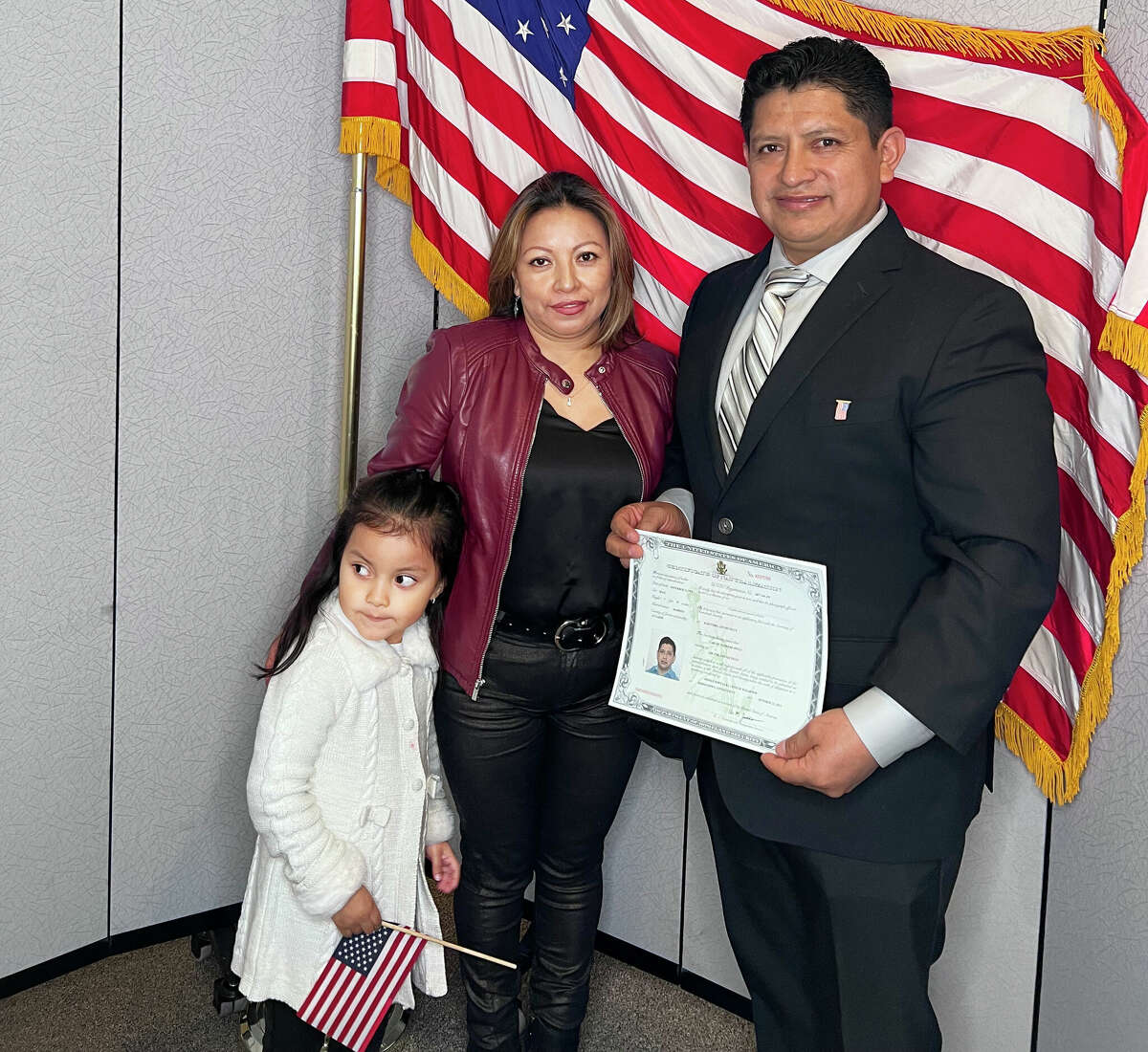 Carlos Pucci of Greenwich, right, stands with his wife Silvia, center, and daughter Ashley, left. Pucci, who emigrated from Ecuador, became a U.S. citizen Friday at the Middletown Elks Club.