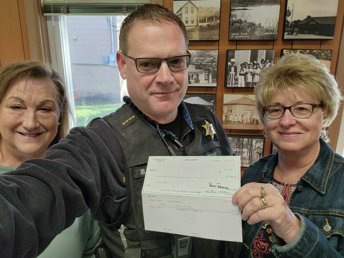 Lake County Sheriff Rich Martin presented a check for $200 to the Sauble Township recently to support the annual Trunk-or-Treat event, as part of the ongoing LCSO Charitable Campaign. Accepting the donation is township supervisor Mary Ann Nugent (left), and township clerk Gail Raad (right). 