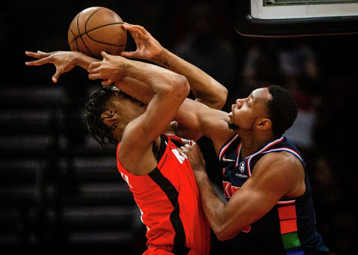 Houston Rockets guard Josh Christopher (9) gets blocked by Philadelphia 76ers center Charles Bassey (23) muring a game at the Toyota Center, Monday, Jan. 10, 2022, in Houston. Philadelphia 76ers won 111-91 against the Houston Rockets.