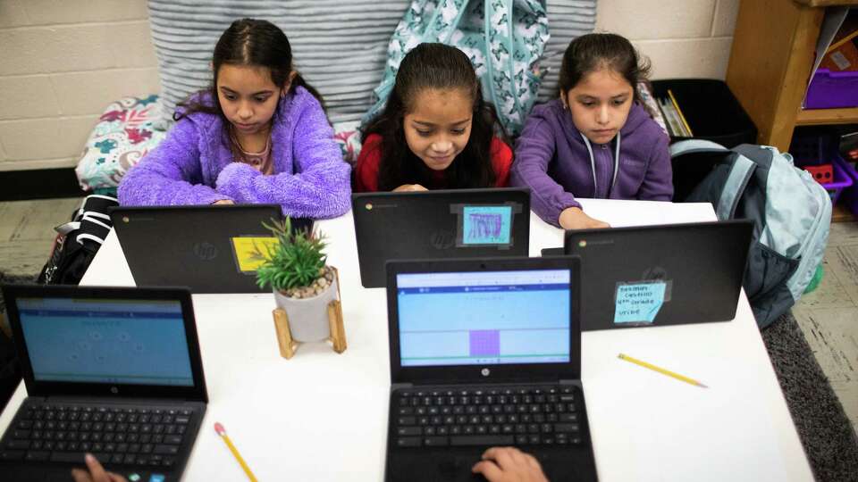 Goodman Elementary fourth grade students, left to right, Genesis Peña, 9, Aliah Rivas, 9, and Yasmin Castillo, 9, work on math assignments in their classroom, Monday, Oct. 24, 2022, in Alief.