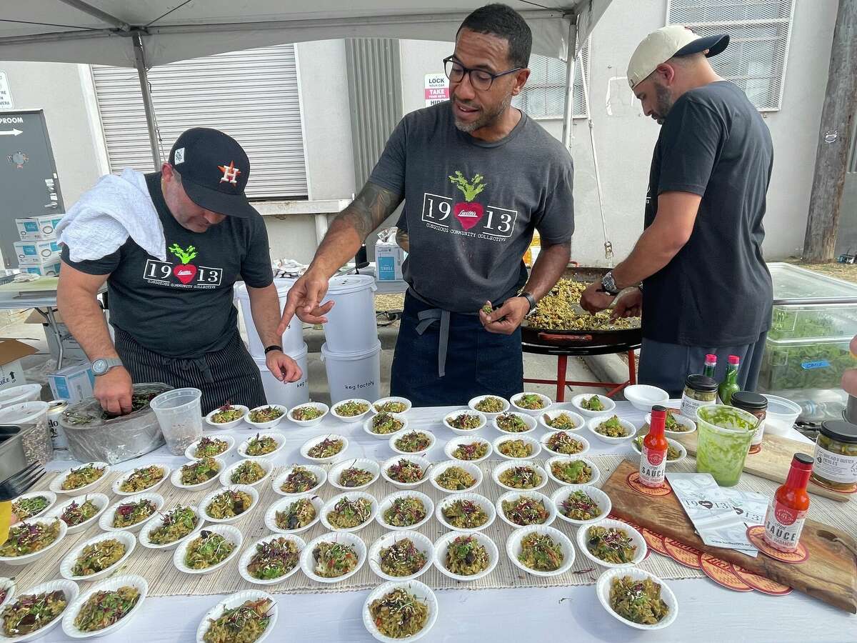 Chef Chris Williams (center) serves West African rice at the 2022 Southern Smoke Festival.