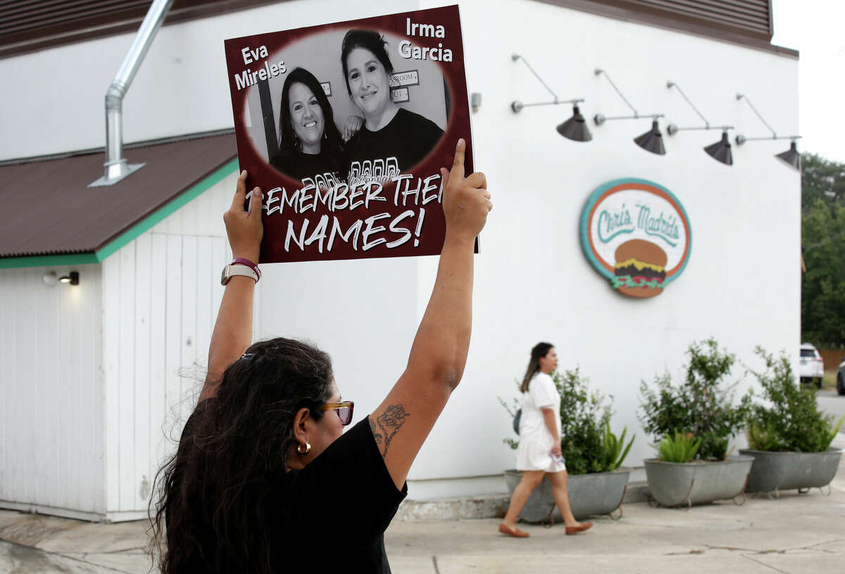 Beto O'Rourke supporters including Rosie Garcia, cousin of Eva Mireles, one of the teachers killed in Uvalde, gather near the corner of Blanco Road and W. Rosewood, across the street from Chris Madrids restaurant, where Gov. Greg Abbott held a rally on Monday, Oct. 24, 2022, the first day of early voting.