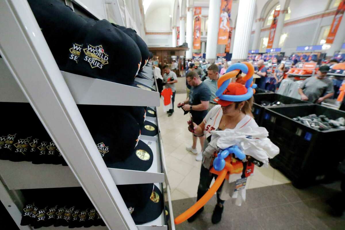 Shopper Lizz Ochoa looks at World Series hats as she and other fans buy up Astros playoff and World Series merchandise Monday, Oct. 24, 2022 at the Team Store at Minute Maid Park in Houston, TX.