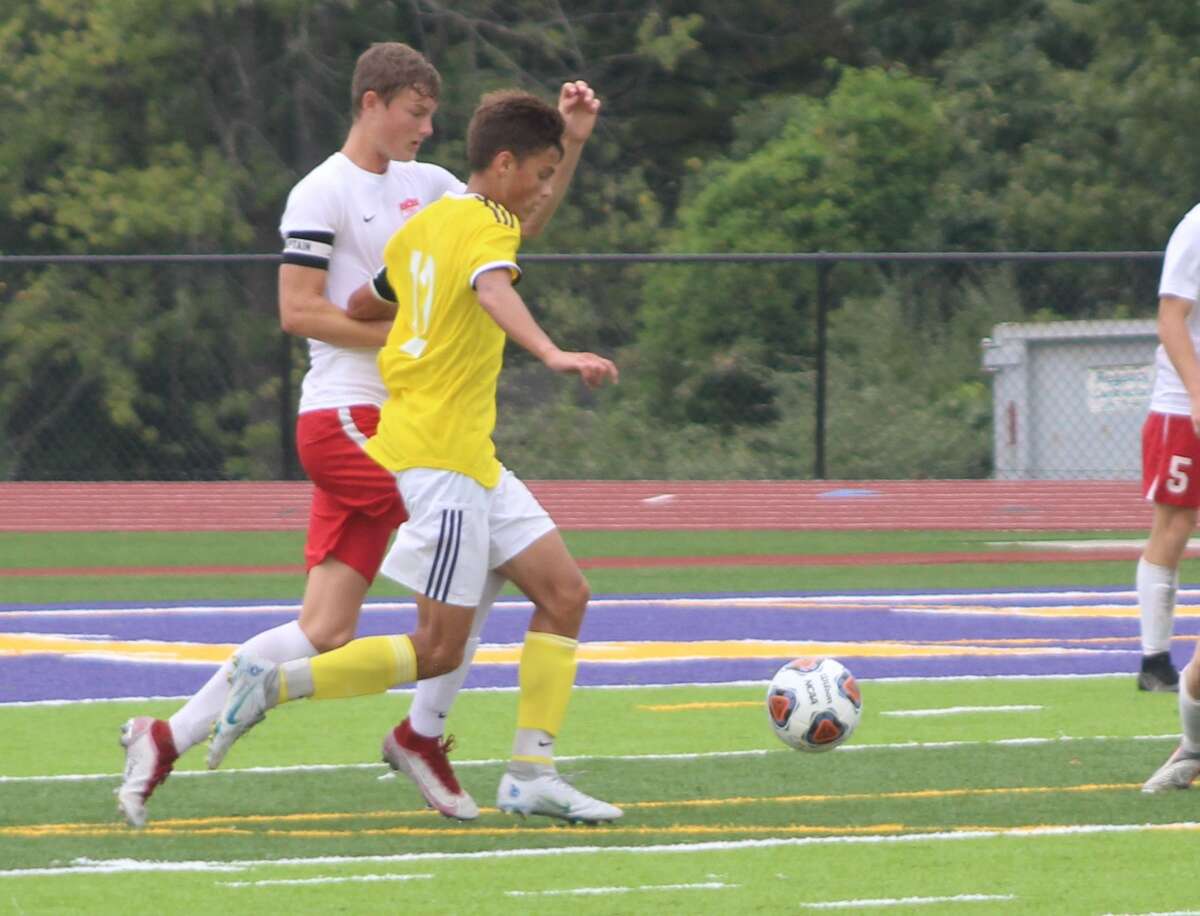 Nick Fiorino of CM, front, and a Triad player race for the ball during action earlier this season. CM, Mascoutah, Triad and Waterloo will play in the Bethalto 2A Sectional Tournament this week at Hauser Field.