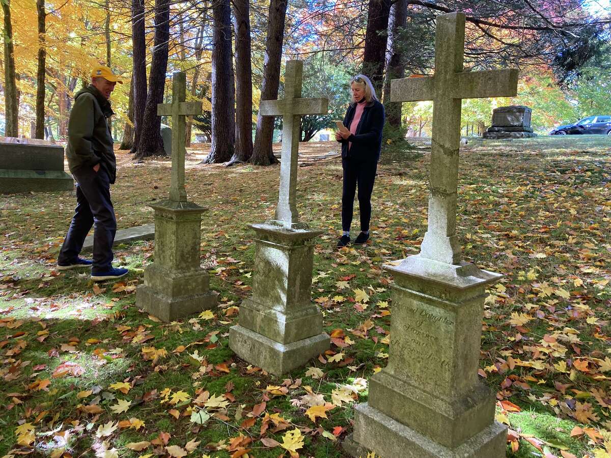 St. John Smith and Kay Barned-Smith are pictured visiting the graves of Smith's ancestors: St. John Smith Sr., Florence Howland Smith, and their daughter, Frances St. John Smith. Oct. 16, 2022/St. John Barned-Smith