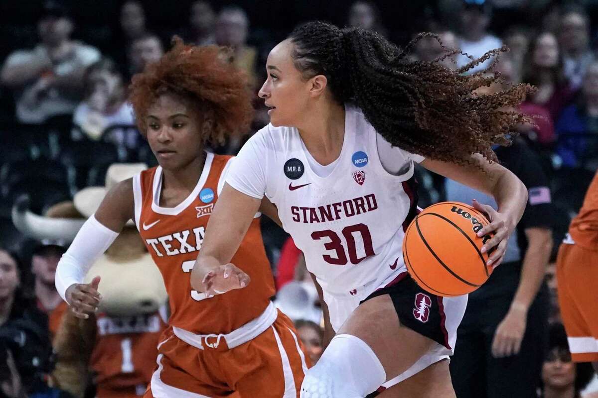 Stanford guard Haley Jones (30) drives around Texas guard Rori Harmon, left, during the first half of a college basketball game in the Elite 8 round of the NCAA tournament, Sunday, March 27, 2022, in Spokane, Wash. (AP Photo/Ted S. Warren)