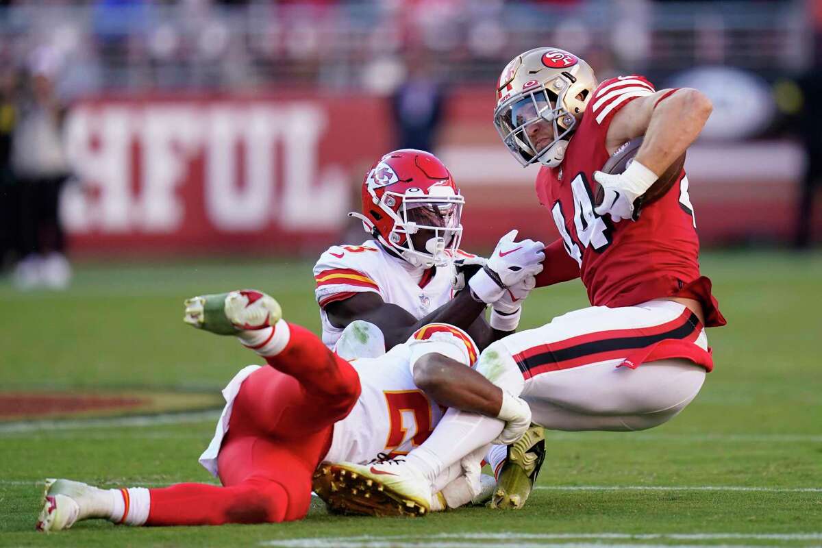 49ers fullback Kyle Juszczyk is tackled Sunday by Kansas City Chiefs cornerback Joshua Williams (center) and safety Justin Reid.