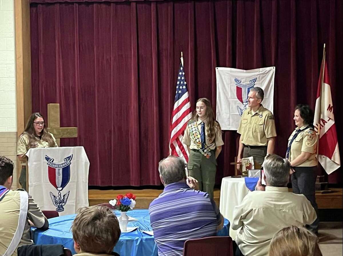 Corrie Groth, far left, presents the Eagle Scout Award to Chloe Adam on Oct. 24, 2022.
