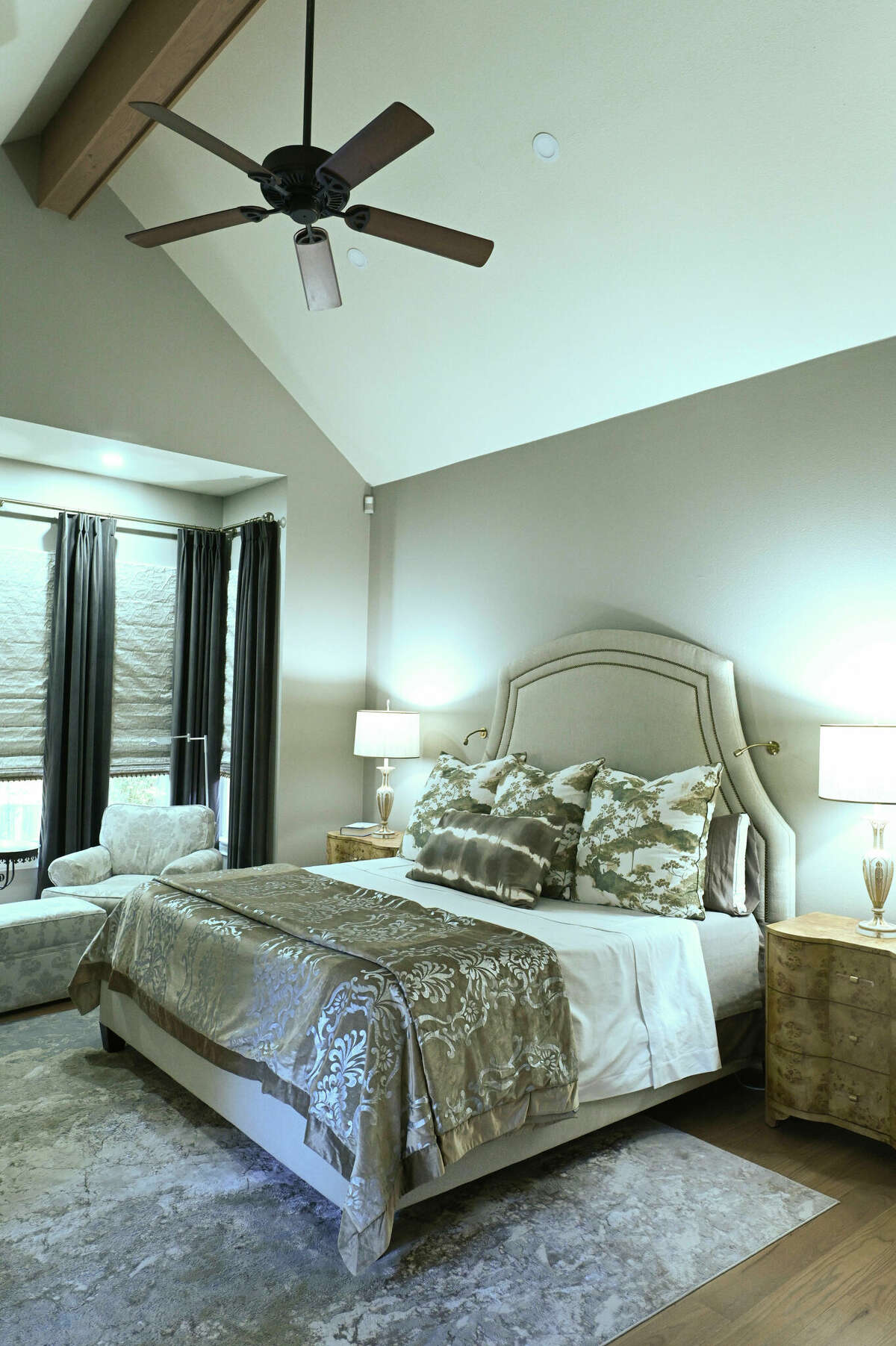 The owners' bedroom was made into a refuge with warm grays from the walls to the all-new fixtures and furnishings, including window treatments and headboard.