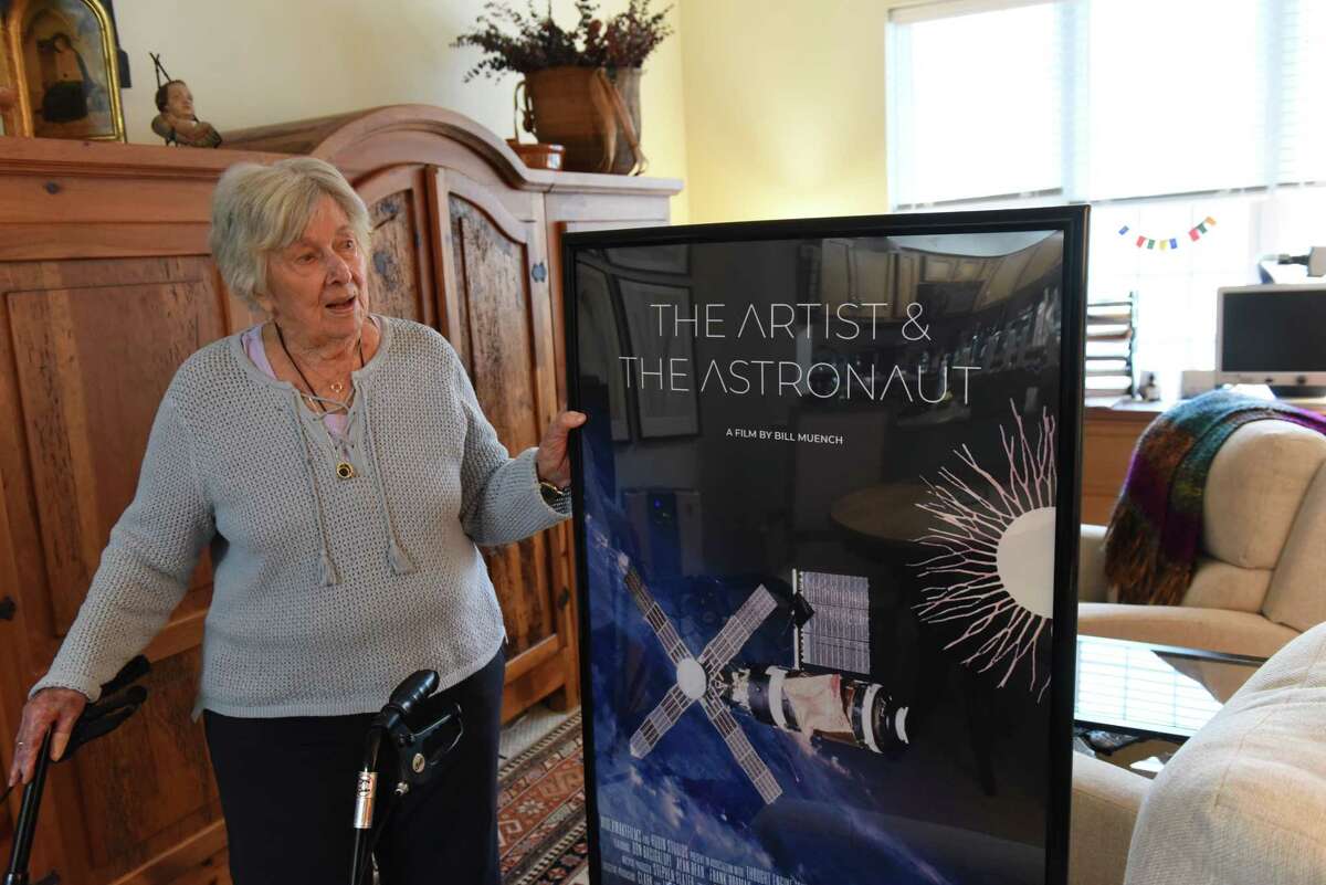 Pat Musick Carr, acclaimed artist, activist and subject of the forthcoming "The Artist & The Astronaut," holds a poster for the film during an interview in her apartment on Monday, Oct. 24, 2022, at Shaker Pointe in Colonie, N.Y.