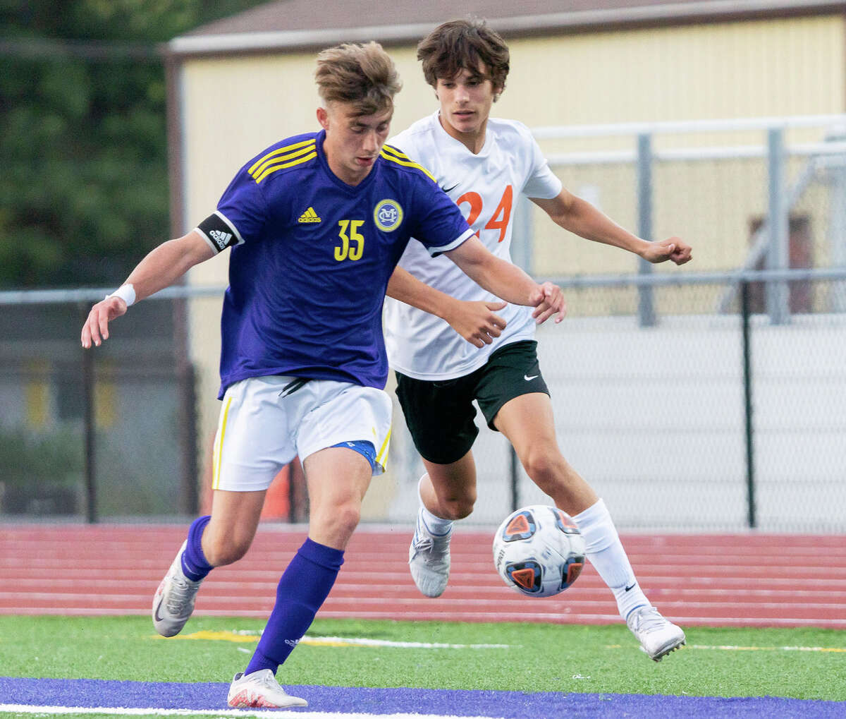 Bryce Harris of CM, left, and Waterloo's Patrick Nobbe battle for the ball in a Mississippi Valley Conference game earlier this season at Hauser Field in Bethalto.