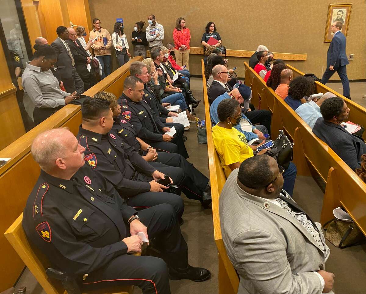 Constable deputies and other law enforcement officials wait to speak during last Tuesday's Harris County Commissioners Court meeting.