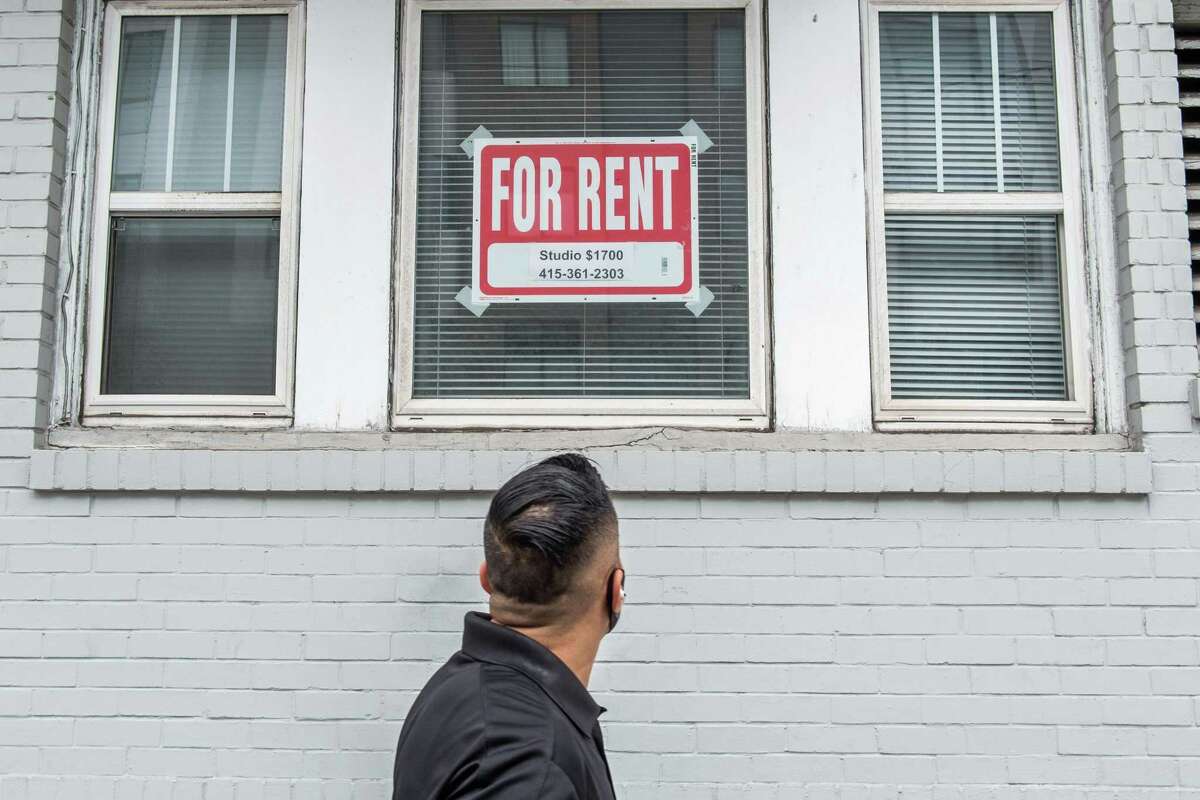 A pedestrian looks up at a “For Rent” sign in a window on Hayes Street in San Francisco on Friday, October 9, 2020. San Francisco’s median one-bedroom apartment rent fell in October as the city’s recovery from the pandemic continues to lag.