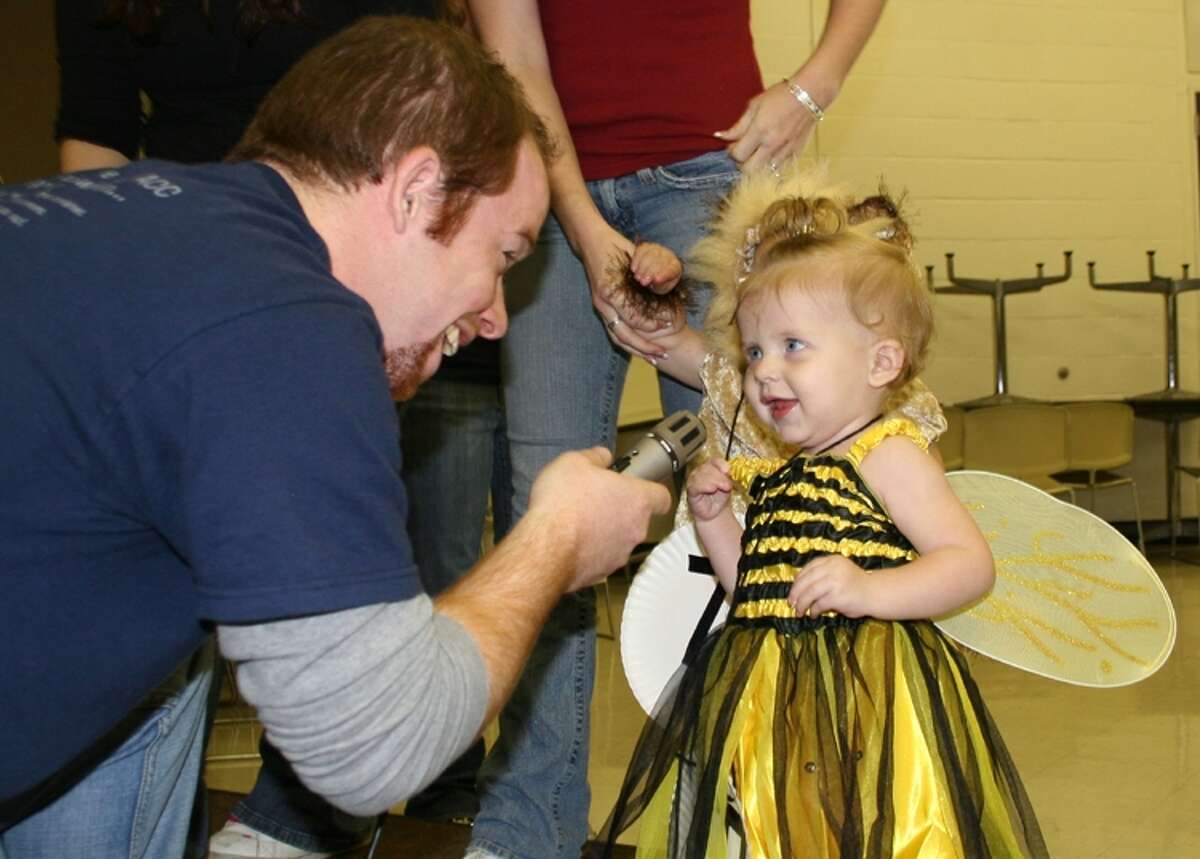 Lily Beth Raymond, 1, of Alvin is interviewed during a costume contest at a 2008 Fall Festival & Carnival at Alvin Community College. 