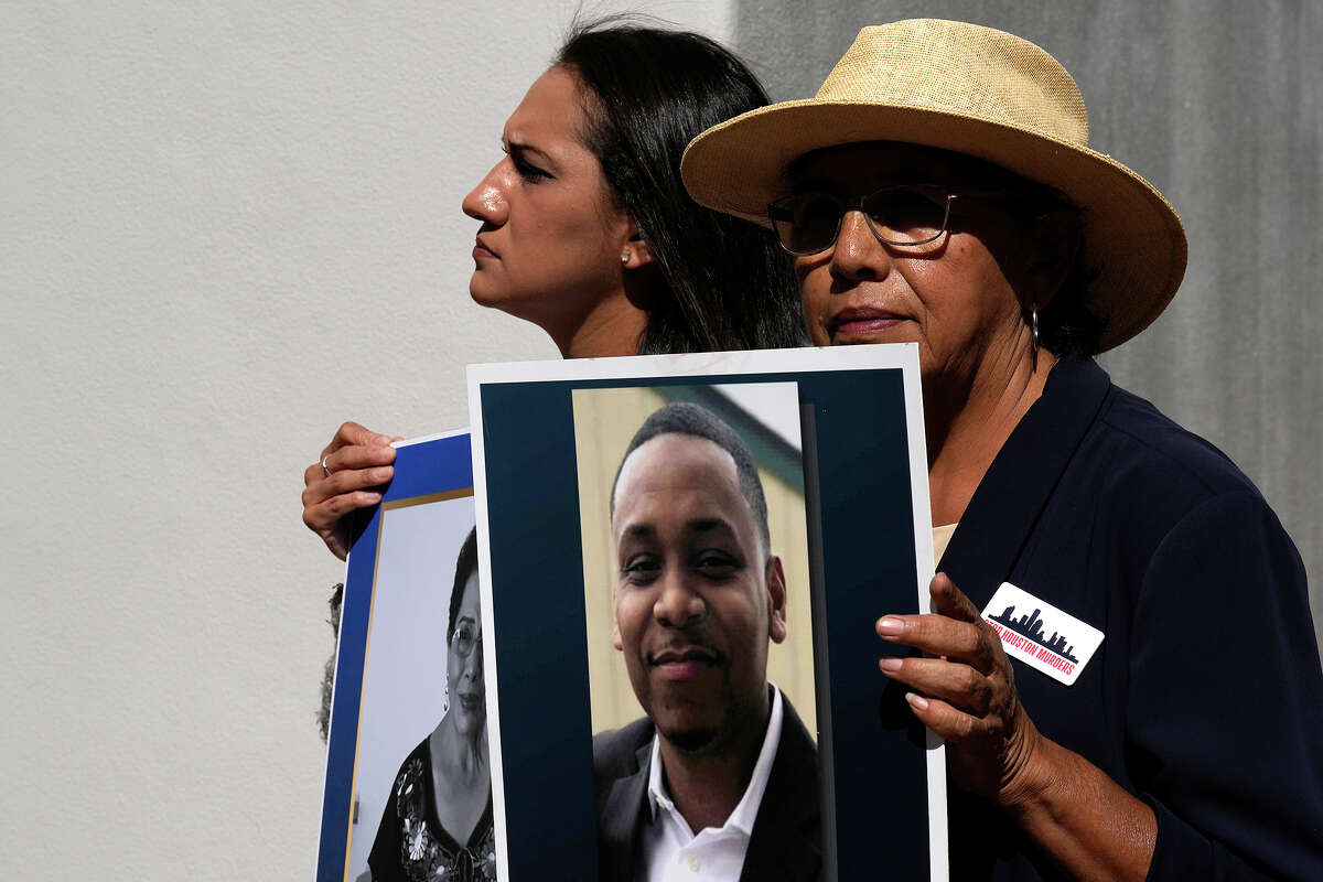 Aimee Castillo and Sara Mejia hold photos of victims of crime Martha Medina and Josh Sandoval during a press conference, Tuesday, Oct. 25, 2022, in Houston, organized by Stop Houston Murders which comprises of families of Houstonians murdered by criminals.