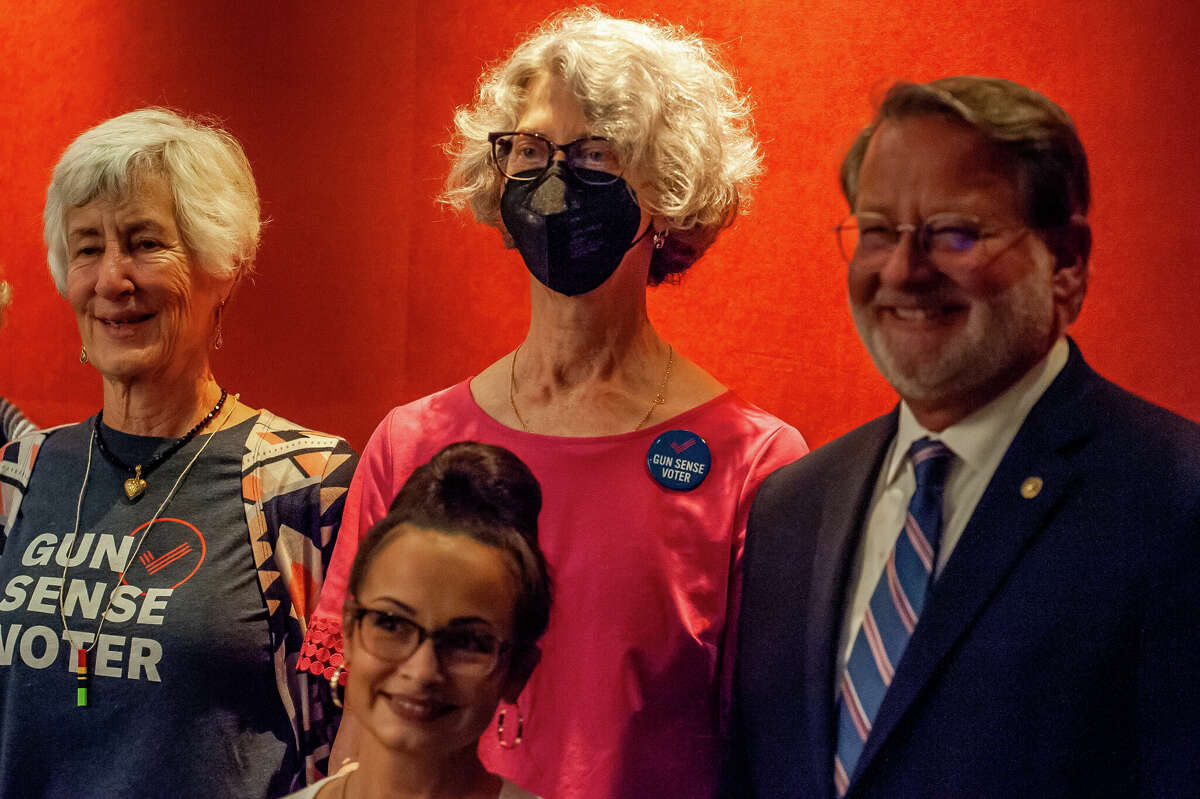 Midland County Commission candidate Allison Wilcox (center) poses with U.S. Sen. Gary Peters at a campaign event for Kristen McDonald Rivet on Oct. 25, 2022 in the H Hotel in Midland.