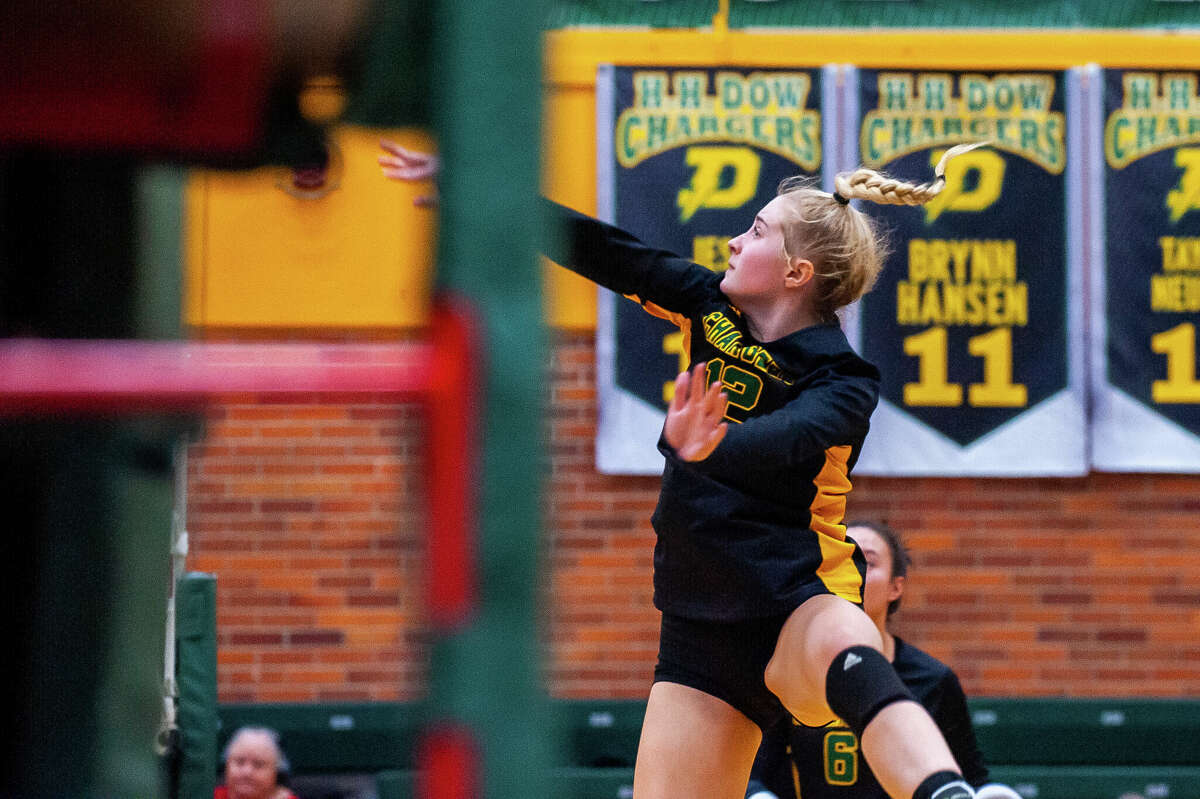 Midland High volleyball player Jenna Rekeweg hits a volleyball during a rivalry game Oct. 25 at Dow High School.