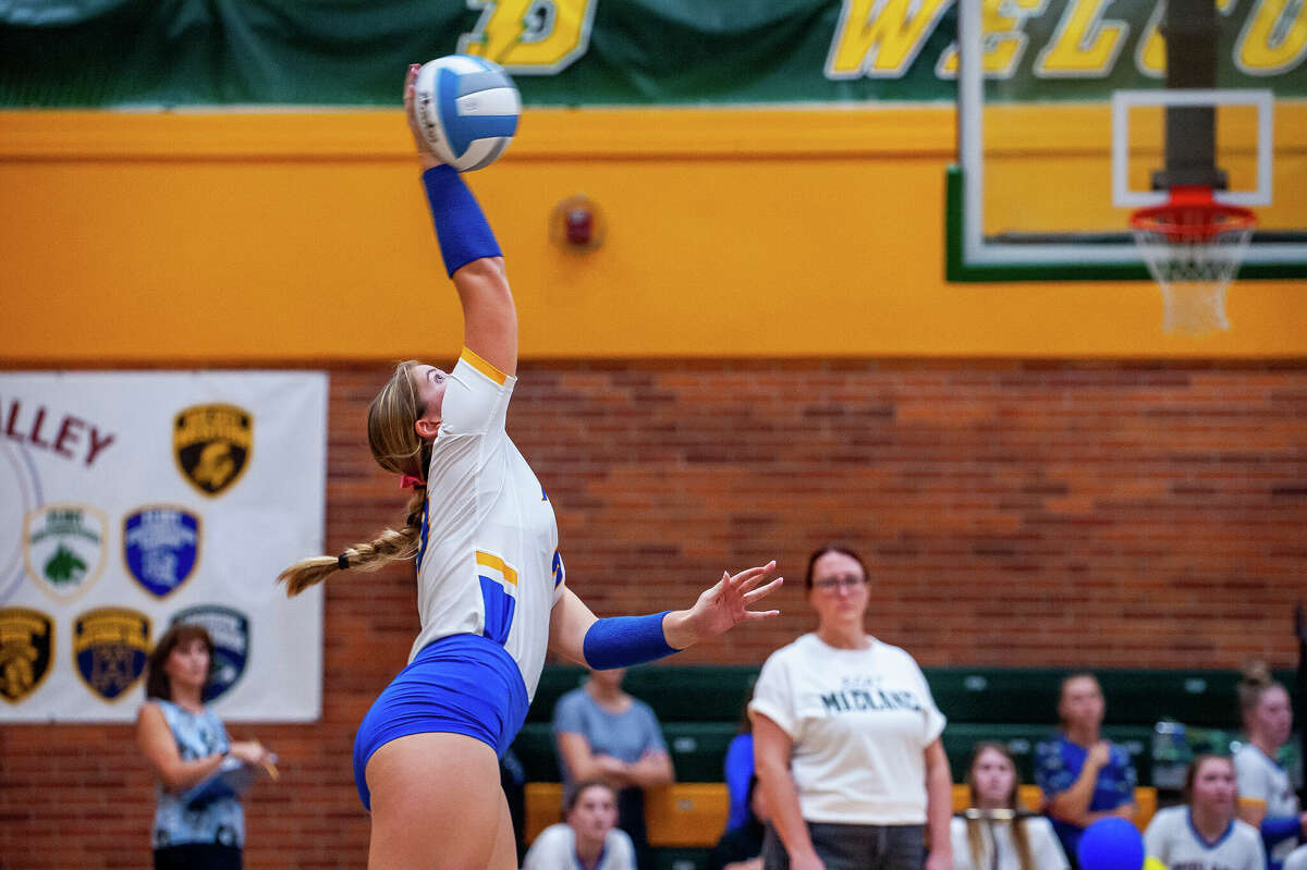 Midland High volleyball player Ellie Stevens hits a volleyball during a rivalry game October 25 at Dow High School.
