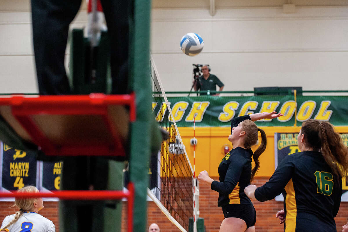 Dow High volleyball player Jessica Erickson hits a volleyball during a rivalry game October 25 at Dow High School.