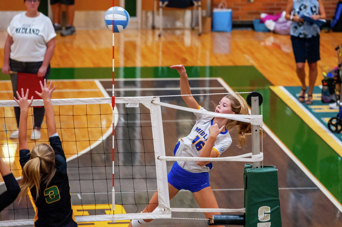 Midland High volleyball player Jenna Rekeweg hits a volleyball during a rivalry game Oct. 25 at Dow High School.