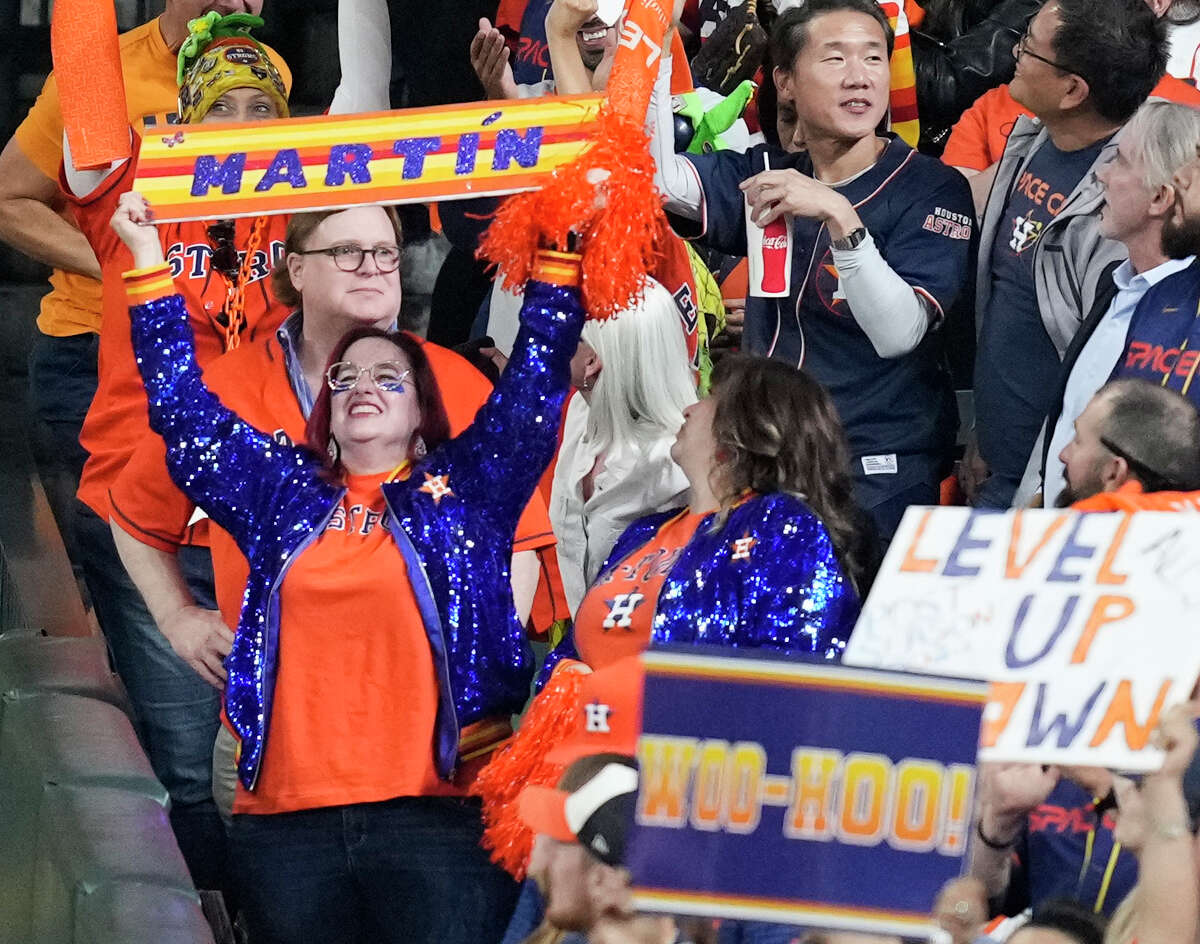 Houston Astros fans sparkle and cheer during the second inning of Game 1 of the American League Championship Series at Minute Maid Park.