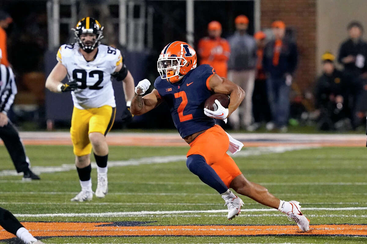 Illinois running back Chase Brown carries the ball against Iowa earlier this season in Champaign.