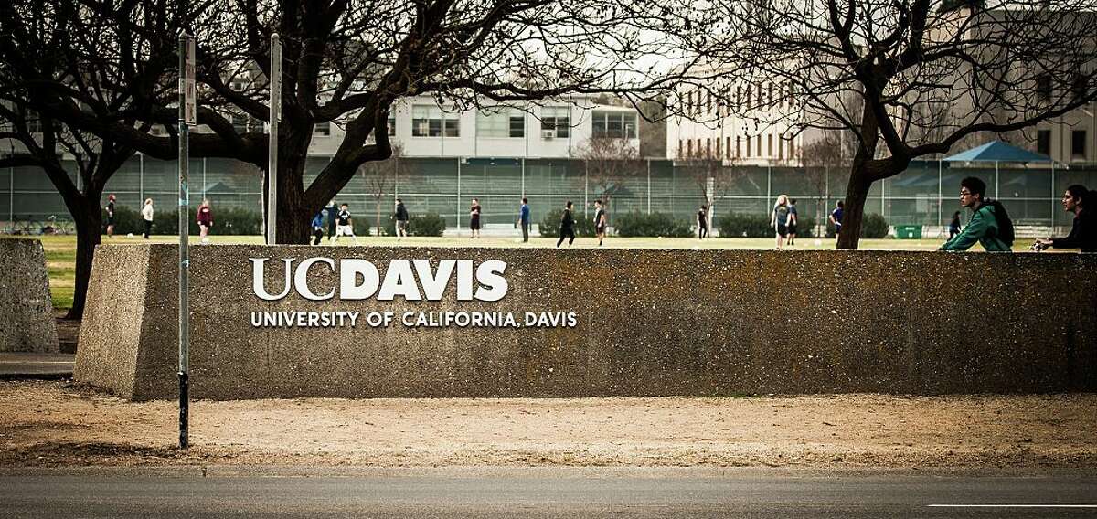 FILE - The UC Davis logo with a soccer game and bike riders in the background. University of California at Davis. Davis, California. Taken February 2, 2015.