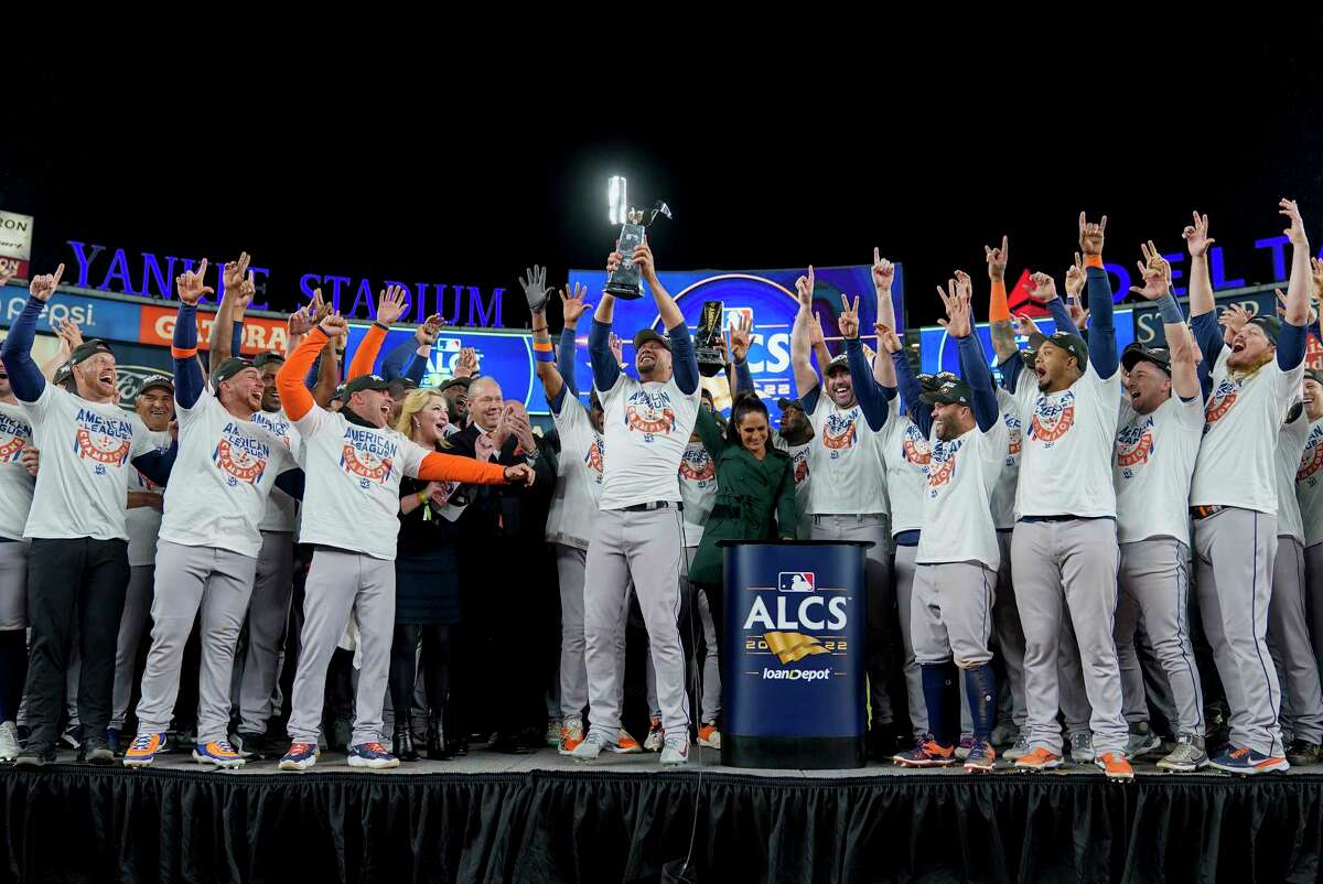 The Houston Astros celebrate with the American League Championship trophy after defeating the New York Yankees in Game 4 to win the American League Championship baseball series, Monday, Oct. 24, 2022, in New York.