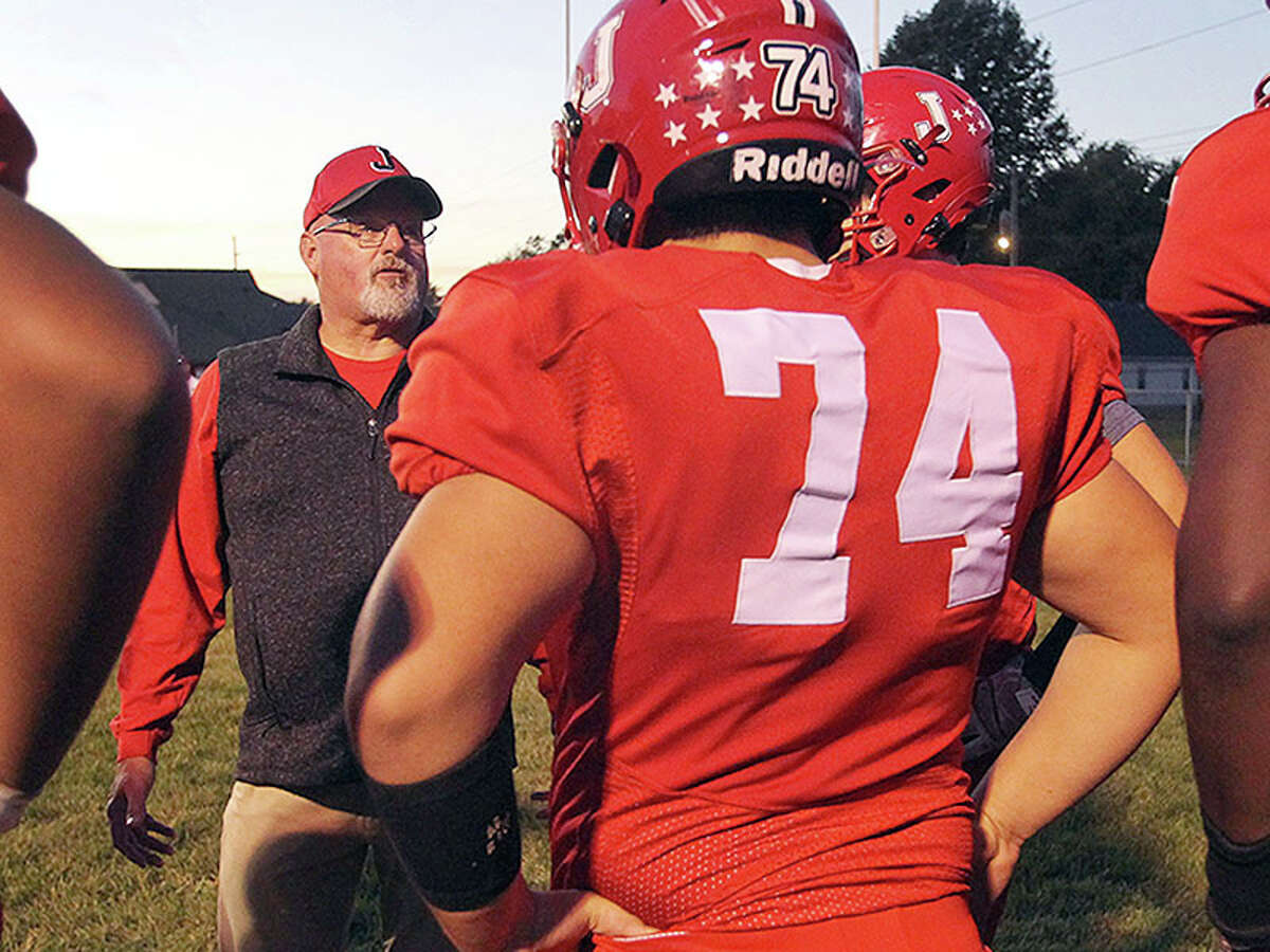 Former Jersey High coach Chris Skinner talks to Jacksonville players prior to a game against Normal University High this season. Skinner, who retired last spring from teaching and coaching at Jersey High School after 34 years, is serving as Jacksonville's offensive line coach this season.