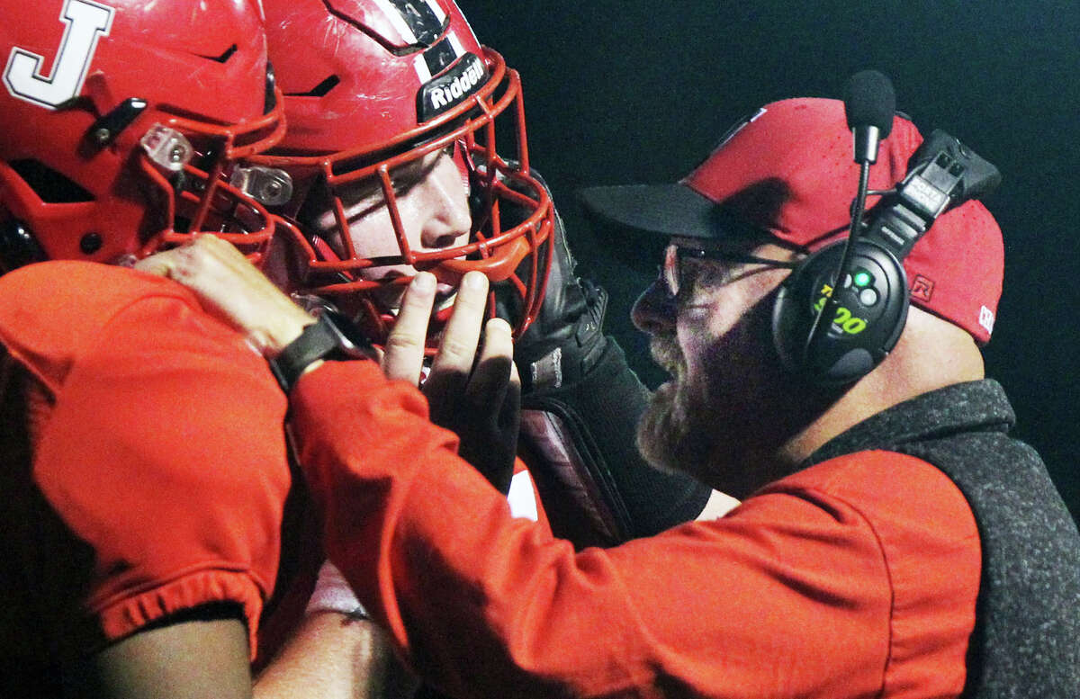 Jacksonville offensive line coach Chris Skinner encourages a Crimsons player during action against Normal University High earlier this season. Skinner retired last spring after 34 years at Jersey