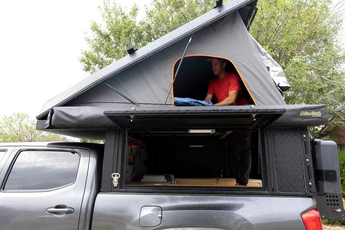 Jared Voeller opens up the tent attached to a camper built into the bed of his pickup truck. He has sued Outdoorsy Inc., an online RV rental marketplace, for more than $1 million over the rental of his vehicle to a man with a criminal background.