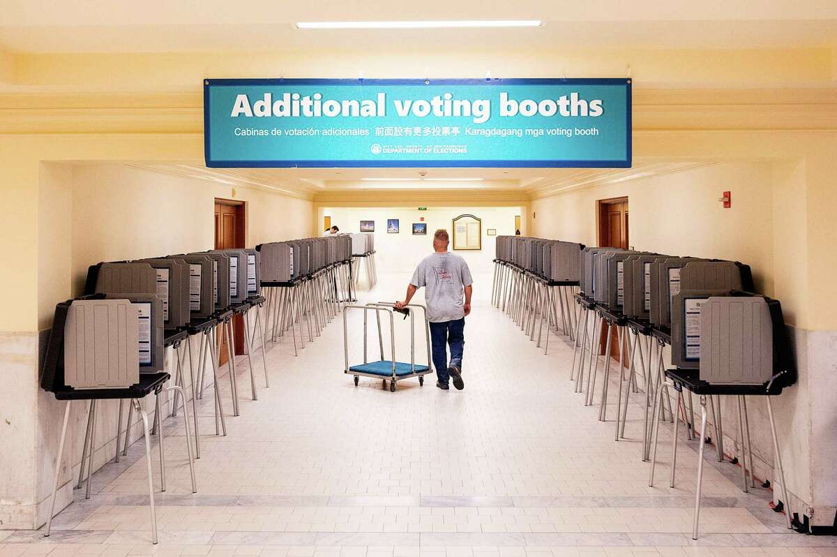 Voting booths line a hallway at San Francisco City Hall.