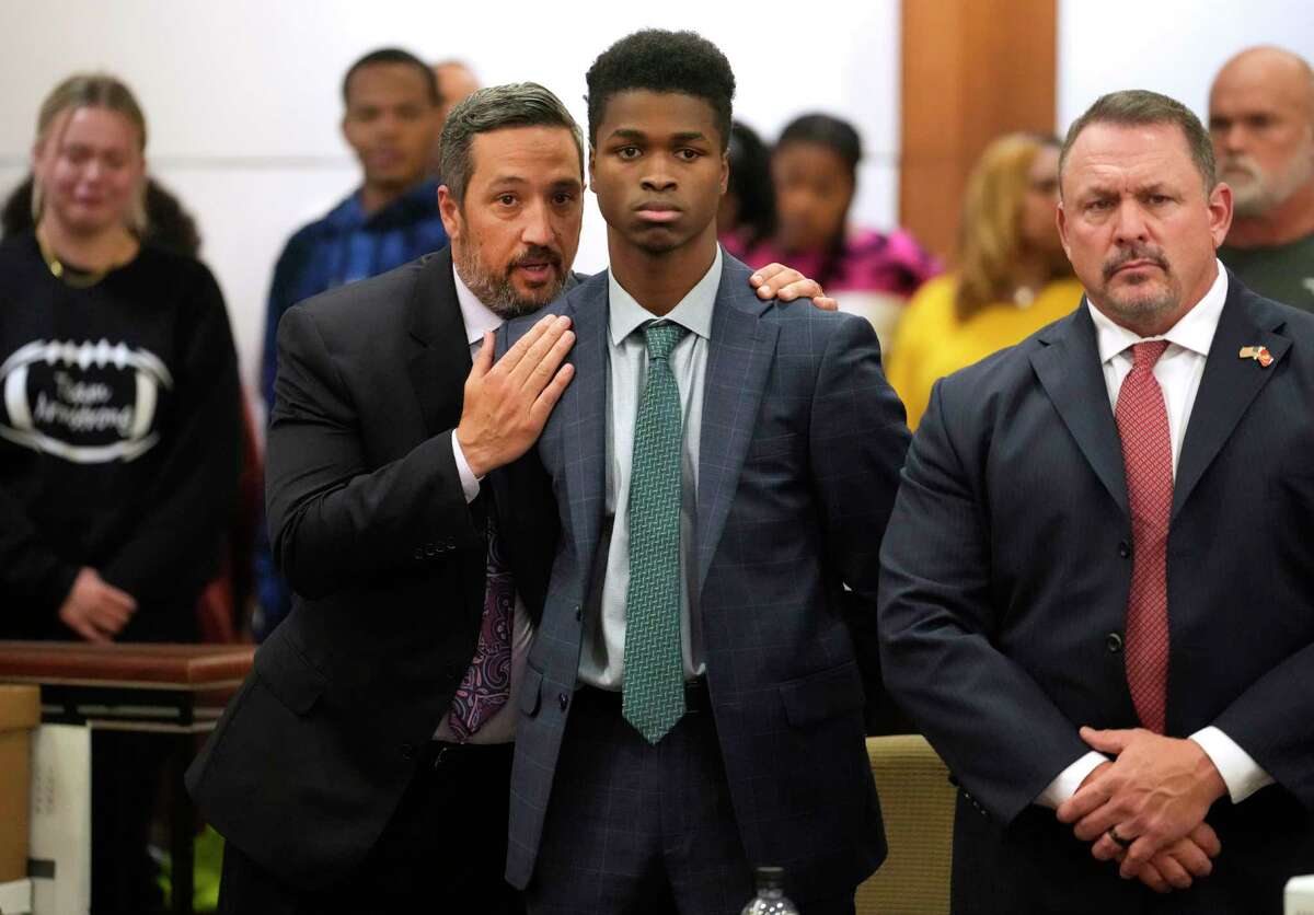 Defense attorneys Rick DeToto, left, and Chris Collings, right, with their client Antonio Armstrong Jr., center, react in the 178th District Criminal Court after a mistrial is declared in his capital murder trial Wednesday, Oct. 26, 2022, in Houston. Armstrong is accused of killing his parents in 2016.