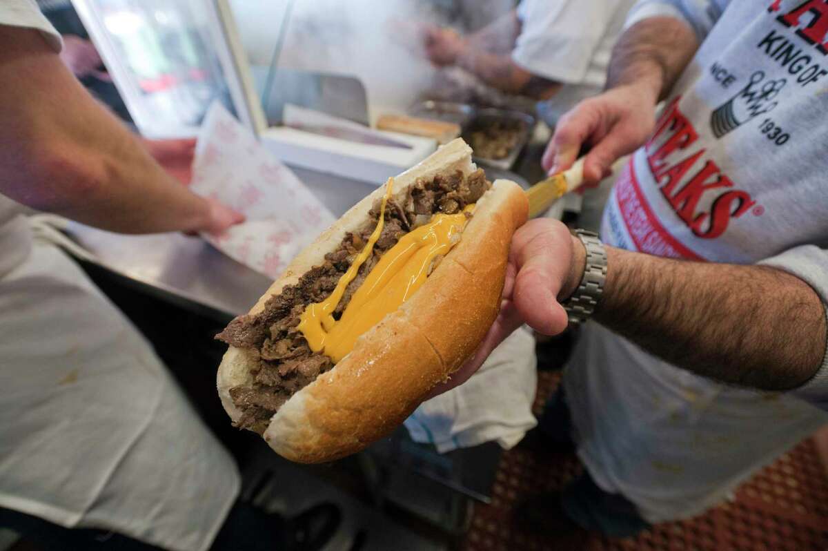 An employee makes a cheesesteak sandwich at Pat's King of Steaks in Philadelphia, Pennsylvania, U.S. on Saturday, Jan. 7, 2012. The restaurant was founded in 1930 by Pat and Harry Olivieri. Photographer: Paul Taggart/Bloomberg