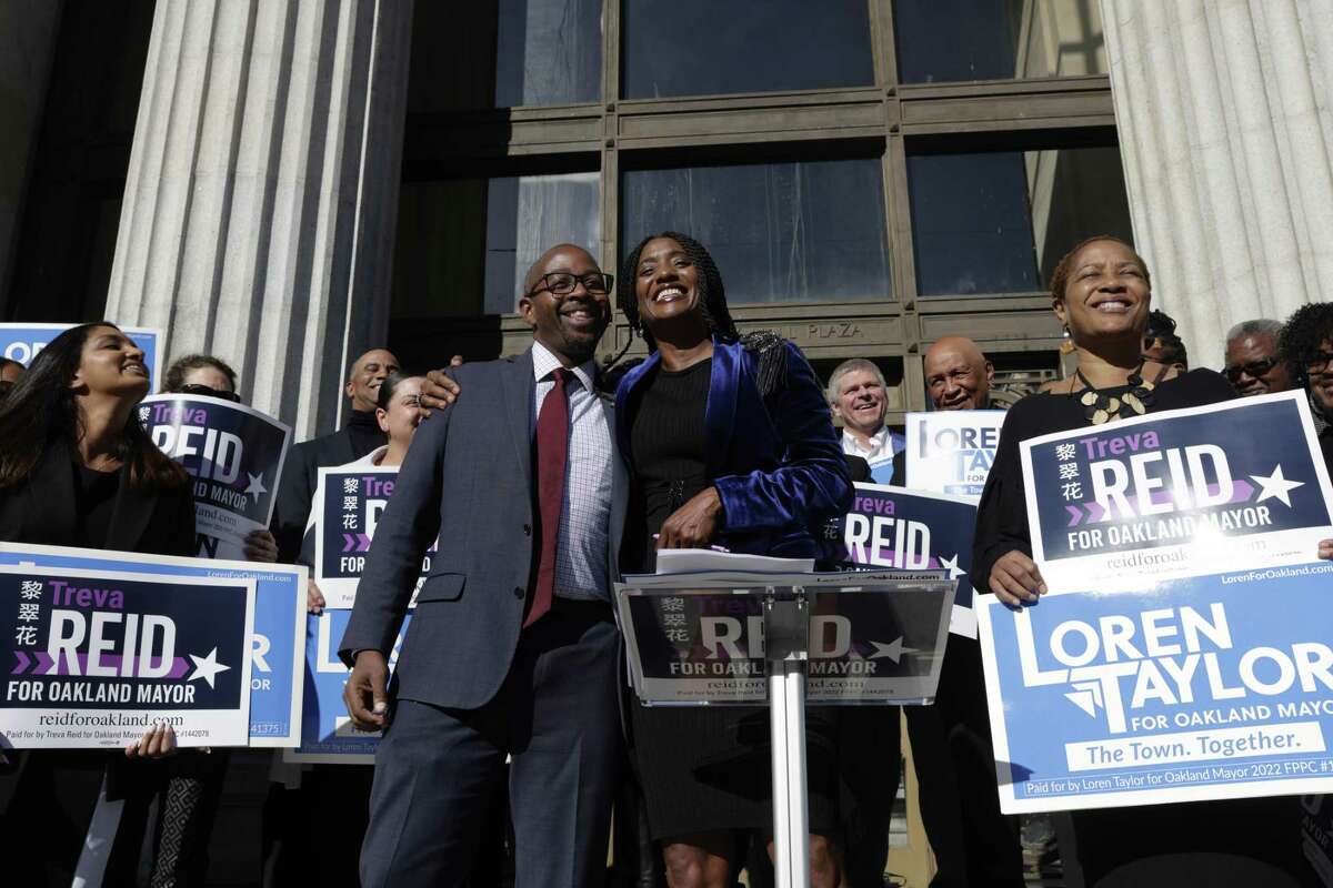 Mayoral candidates Loren Taylor and Treva Reid embrace at Oakland City Hall as they announce they are forming an alliance for ranked-choice voting.