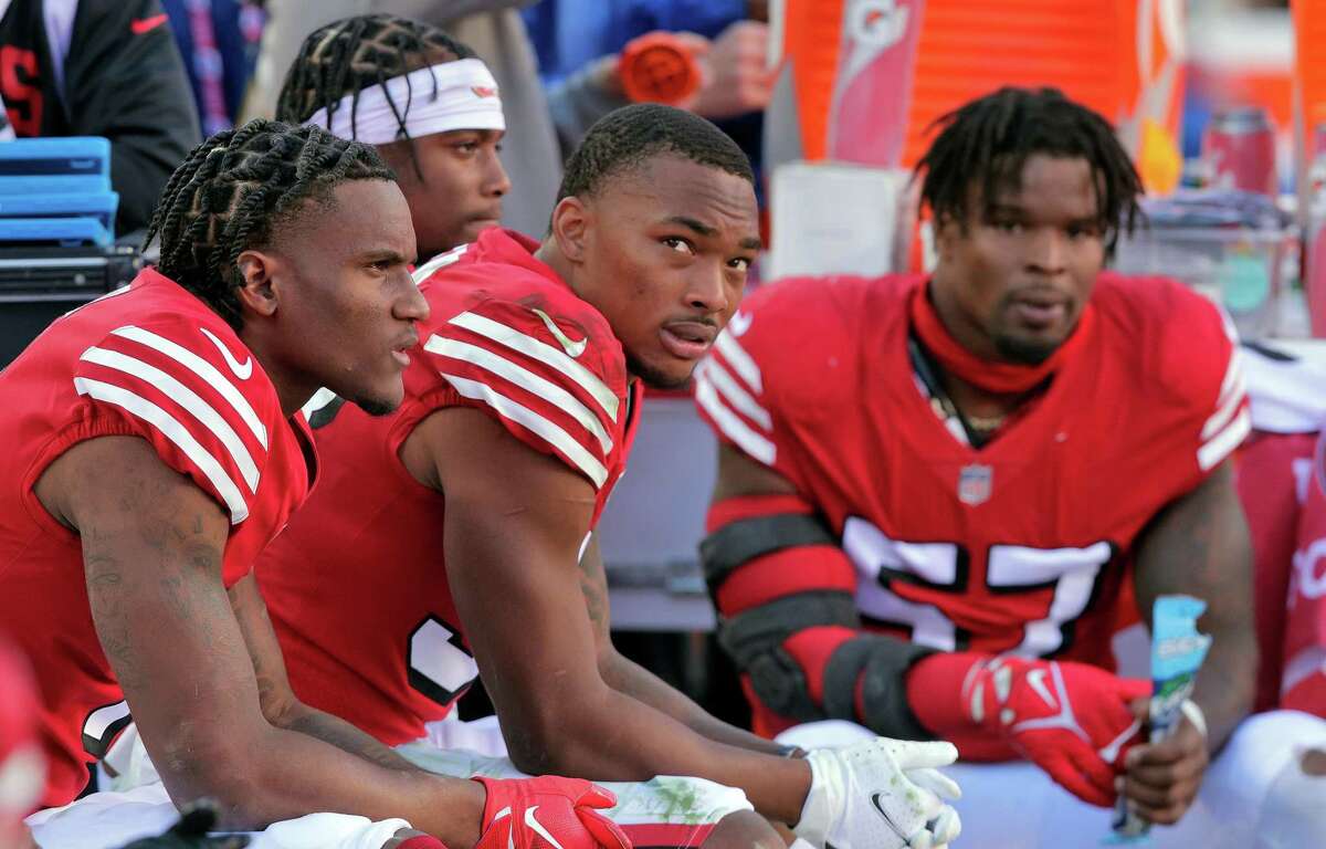 49ers defensive players, from left, cornerback Charvarius Ward (35), cornerback Deommodore Lenoir (38), and linebacker Dre Greenlaw (57) sit on the bench with the game well out of reach in the final minutes of the second half as the San Francisco 49ers played the Kansas City Chiefs at Levi’s Stadium in Santa Clara, Calif., on Sunday, October 23, 2022. The 49ers lost 44-23 to the Chiefs.