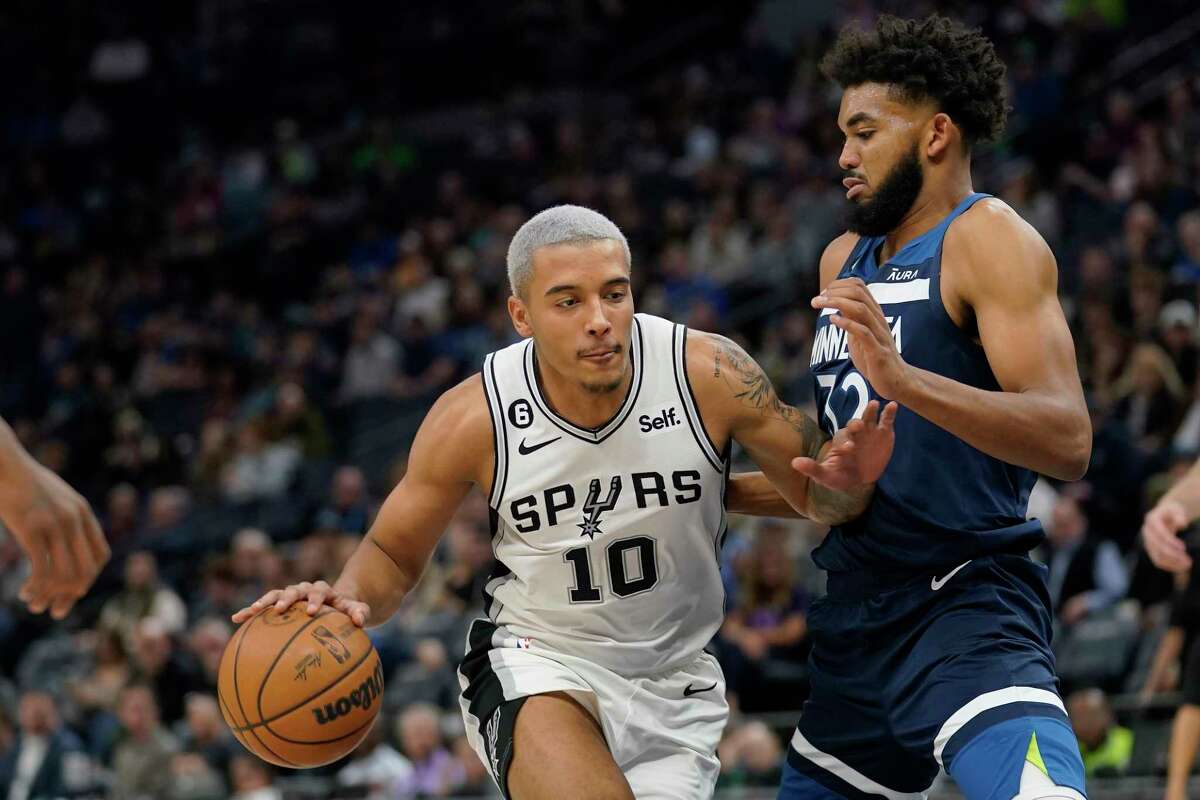 San Antonio Spurs forward Jeremy Sochan (10) works towards the basket against Minnesota Timberwolves center Karl-Anthony Towns (32) during the second half of an NBA basketball game, Wednesday, Oct. 26, 2022, in Minneapolis.