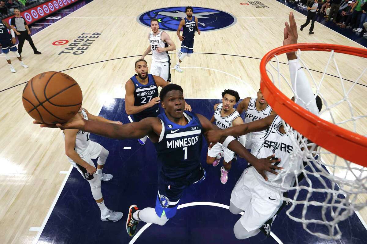 Minnesota Timberwolves forward Anthony Edwards drives to the basket against Spurs guard Josh Richardson during the second half of Wednesday’s game in Minneapolis.
