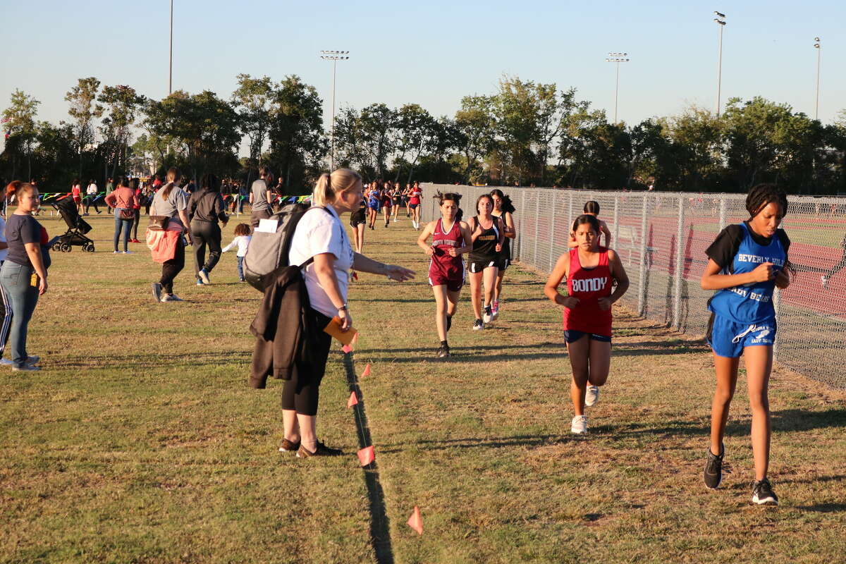 Bondy coach Michelle Dalton yells instructions to her runners to move up in the pack. The Lady Patriots swept the two girls races by the grand total of eight points.