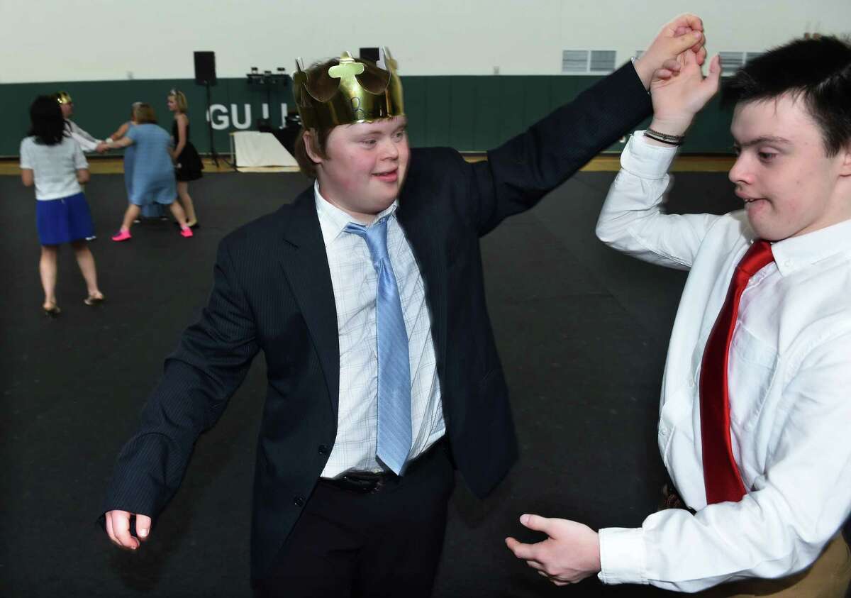 Beau Kellogg, center, dances with Cisco Keyes to the music of a DJ at a unified prom at Guilford High School.