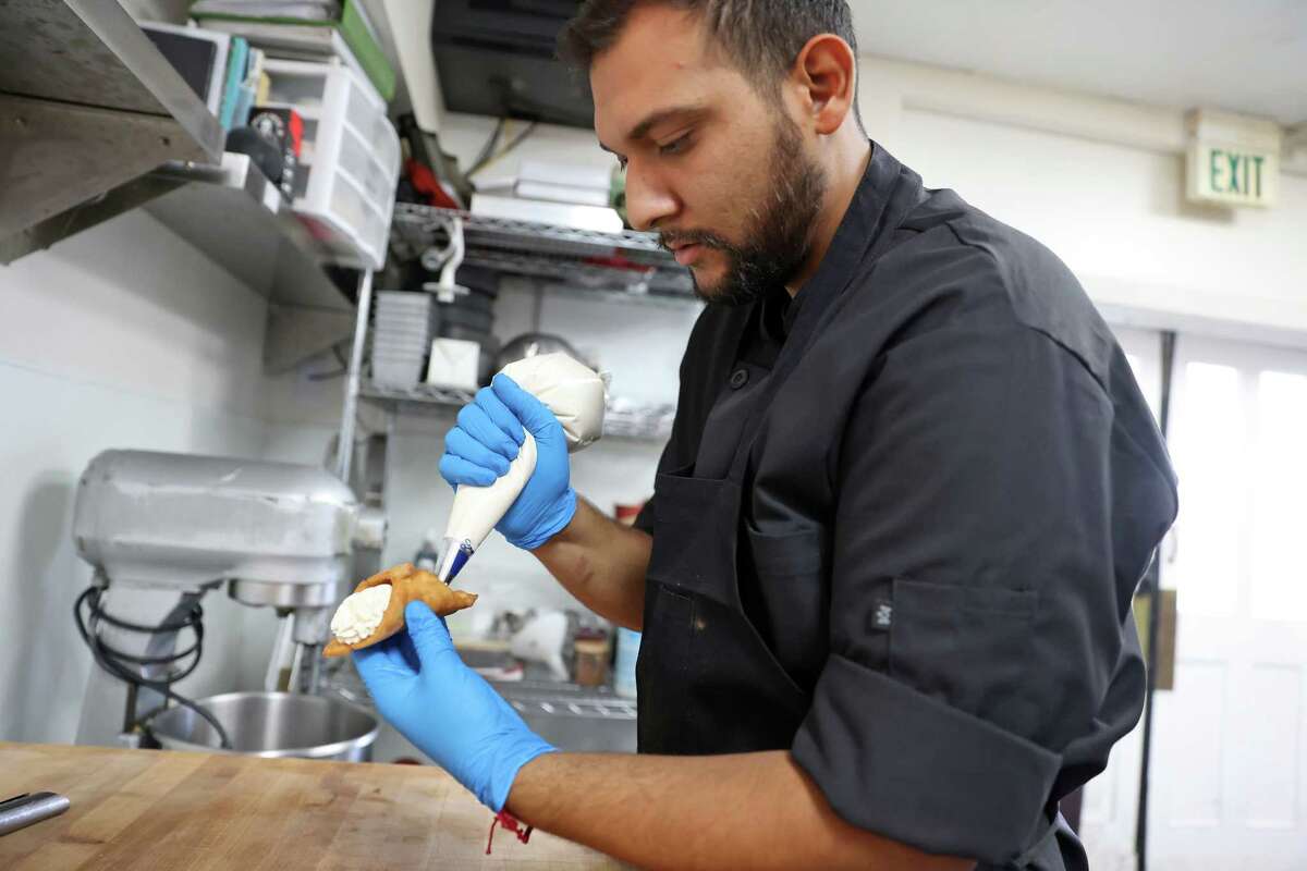 Executive pastry chef Oliver Ruiz fills a cannoli at Polenteria in Los Gatos.