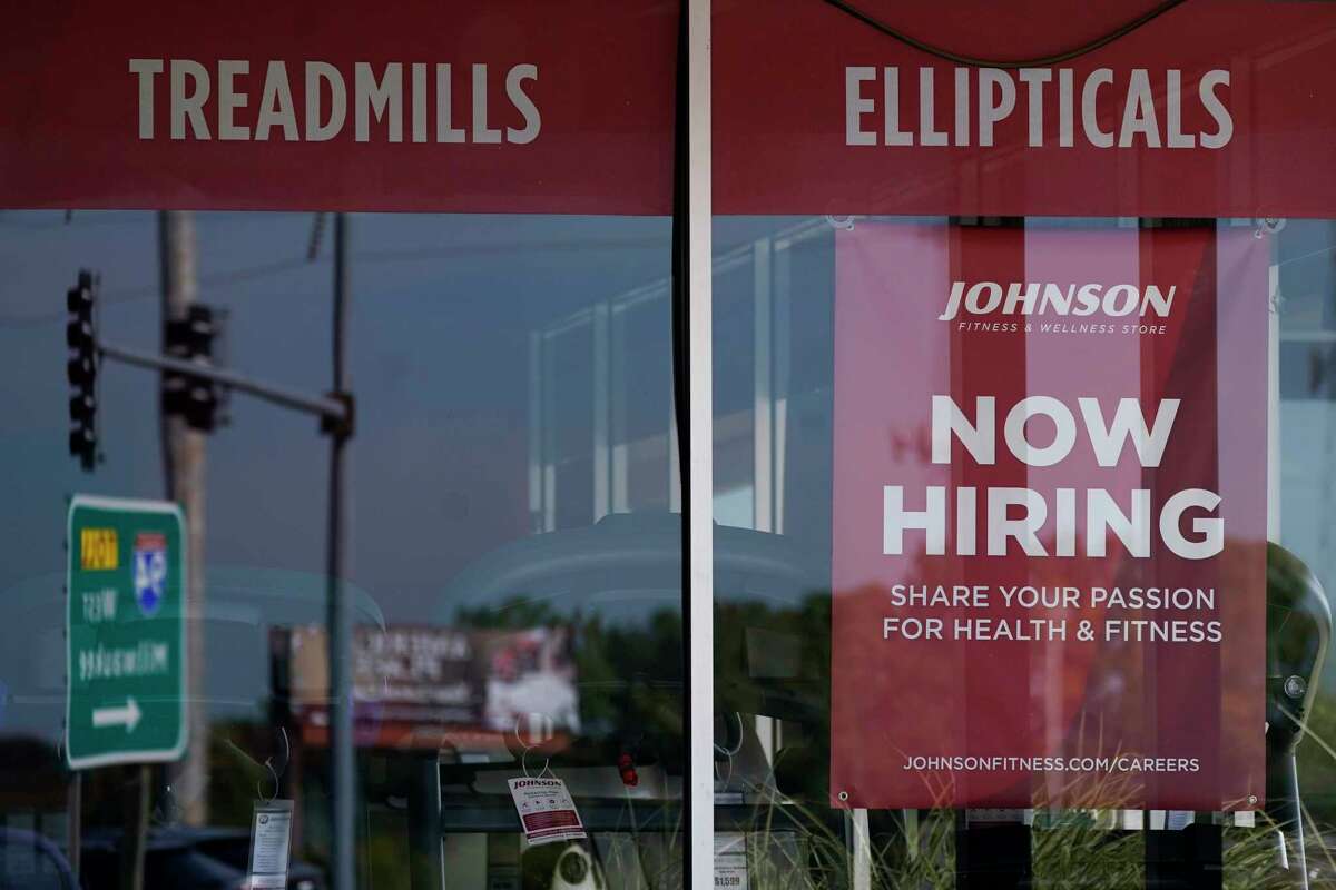 FILE - A "now hiring" sign is displayed in Northbrook, Ill., on Sept. 21, 2022. The U.S. economy grew faster than expected in the July-September 2022 quarter, the government reported Thursday, Oct. 27, 2022, underscoring that the United States is not in a recession despite distressingly high inflation and interest rate hikes by the Federal Reserve. But the economy is hardly in the clear.