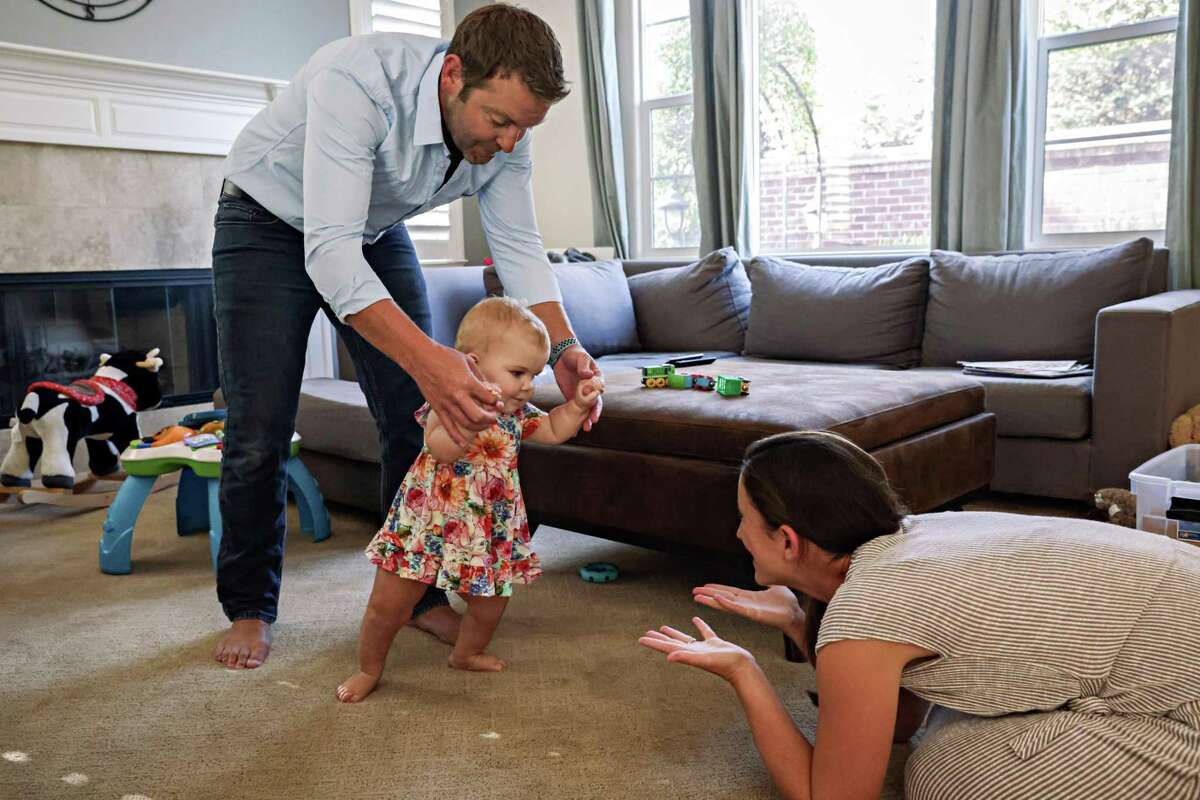 Zach Landman practices walking with Lucy while Geri Landman offers encouragement at their home in Danville in August.