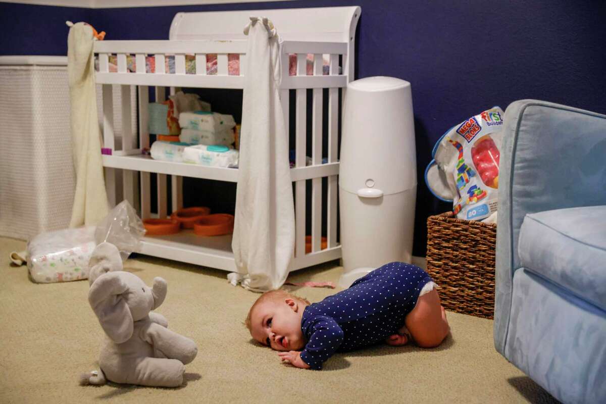 Lucy looks at a toy elephant in her room in September. Lucy has two faulty copies of the PGAP3 gene, which plays a critical role in cellular communication. The resulting disorder causes symptoms across multiple organ systems. Because of her condition, Lucy is delayed in speech, walking and other motor skills.