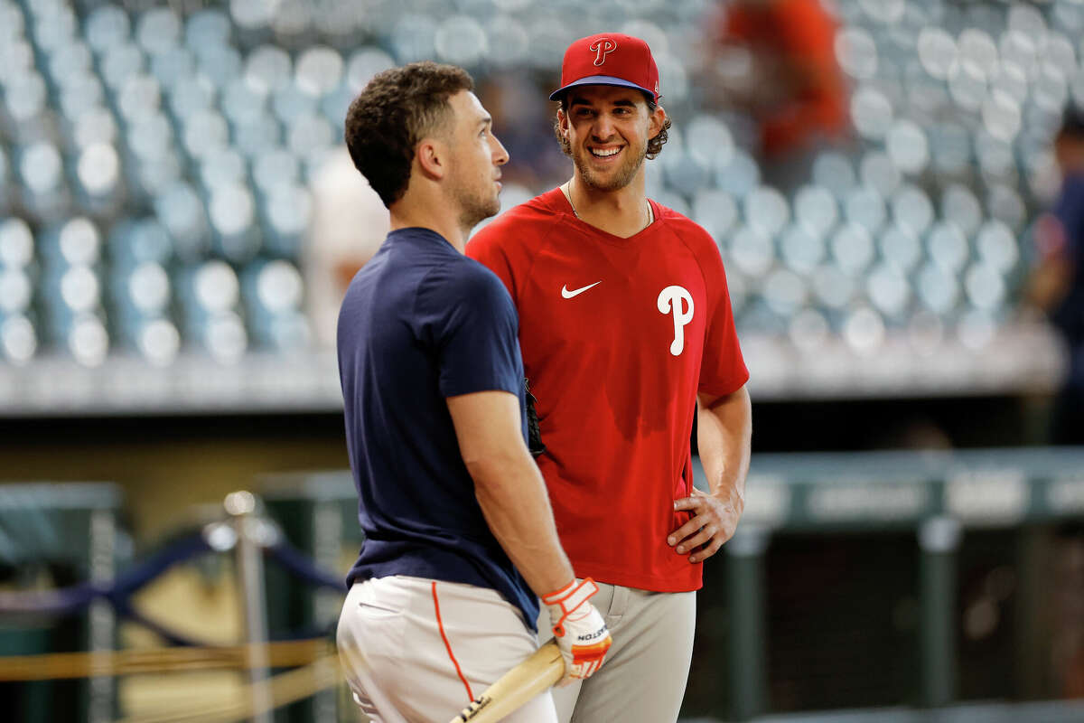 Aaron Nola of the Philadelphia Phillies talks with Alex Bregman of the Houston Astros before the game at Minute Maid Park on October 5, 2022 in Houston.