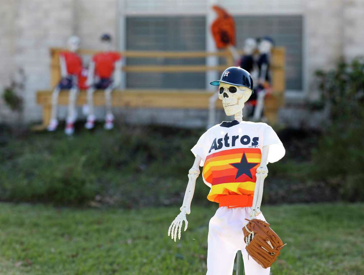 Plastic skeleton dressed as baseball players are seen as part of Patty Norman World Series-themed baseball scene between the Houston Astros and Philadelphia Phillies at her home, Thursday, Oct. 28, 2022, in Willis. Patty and her husband, Wayne, are avid baseball fans, love the Astros and decided to have some fun with the annual Halloween decorating of their Point Aquarius yard.