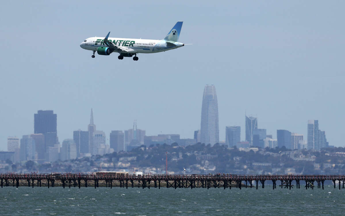 A Frontier Airlines plane lands at San Francisco International Airport in May 2022.