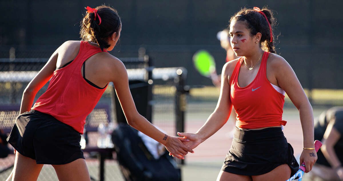 Memorial's Tara Ahmadi, right, high-fives partner Sofia Mazzucato during a doubles match against Round Rock Westwood's Kinaa Graham and Simryn Jacob in the Class 6A tennis state championship finals at the George P. Mitchell and Omar Smith Intramural Tennis Centers at Texas A&M University in College Station on Thursday, October 27, 2022. (Cassie Stricker / The Chronicle)